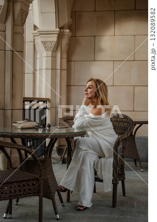 Woman Sitting Cafe Table White Outfit Fashionable Lifestyle Woman Sitting Cafe Table White Outfit Fashionable Lifestyle 132089582