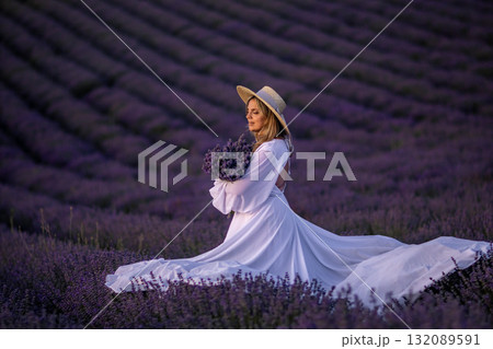 Lavender Provence Woman Dress: Sunset photoshoot, woman in white dress amidst blooming lavender fields in Provence, France. 132089591