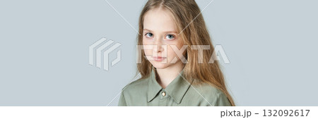 Caucasian young girl with long blonde hair and freckles in olive green shirt Caucasian young girl with long blonde hair and freckles in olive green shirt 132092617