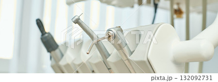 Close-up view of dental tools in clinic setting with focus on handpiece Close-up view of dental tools in clinic setting with focus on handpiece 132092731