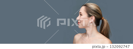 Profile of young caucasian female with ponytail against gray background Profile of young caucasian female with ponytail against gray background 132092747