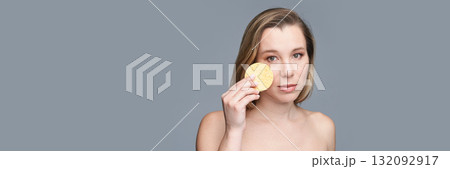 Caucasian adult female with makeup sponge on gray background beauty concept 132092917