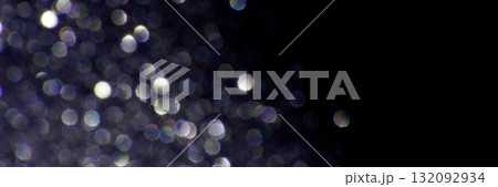 Abstract glittering bokeh lights on dark background capturing nighttime sparkle Abstract glittering bokeh lights on dark background capturing nighttime sparkle 132092934