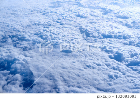 Expansive aerial view of dense white cloudscape across vast sky in natural Expansive aerial view of dense white cloudscape across vast sky in natural 132093093