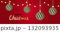 Red and white striped Christmas balls hang on red satin ribbon with bow. 132093935