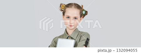 Young caucasian girl holding laptop with unique hairstyle against gray 132094055