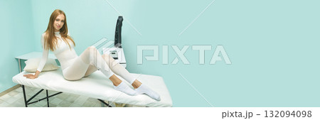 Young caucasian female in white bodysuit relaxing on spa table in aqua room 132094098