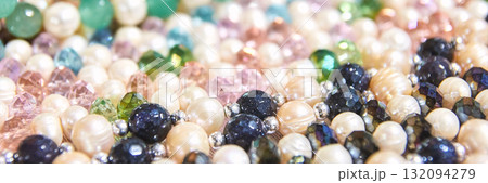 Close-up of colorful pearl and gemstone beads in various shapes and sizes 132094279