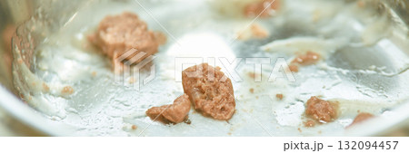 Close-up of cooked meat leftovers in stainless steel pan after frying Close-up of cooked meat leftovers in stainless steel pan after frying 132094457