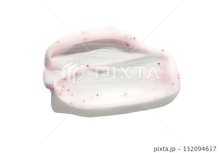 Swirl of pink facial cream with red exfoliating beads on white background 132094617
