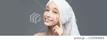 Young caucasian female skincare routine with towel turban and moisturizing 132094665