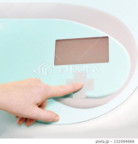 Close-up of hand operating modern medical device with display screen Close-up of hand operating modern medical device with display screen 132094666
