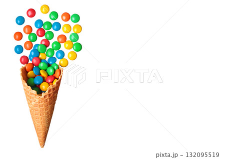 Creative composition of a waffle cone with colorful candies spilling out, isolated on a transparent background Creative composition of a waffle cone with colorful candies spilling out, isolated on a transparent background 132095519