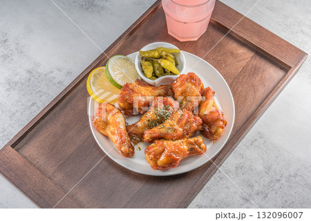 Savor the irresistible allure of these delicious, spicy buffalo chicken wings. Crispy, cooked to perfection and coated in a flavorful sauce, they are sprinkled with sesame seeds Savor the irresistible allure of these delicious, spicy buffalo chicken wings. Crispy, cooked to perfection and coated in a flavorful sauce, they are sprinkled with sesame seeds 132096007