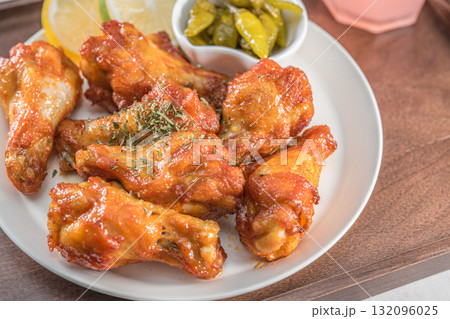 Savor the irresistible allure of these delicious, spicy buffalo chicken wings. Crispy, cooked to perfection and coated in a flavorful sauce, they are sprinkled with sesame seeds Savor the irresistible allure of these delicious, spicy buffalo chicken wings. Crispy, cooked to perfection and coated in a flavorful sauce, they are sprinkled with sesame seeds 132096025