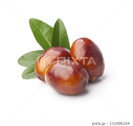 Dates fruits with leaves on white backgrounds Dates fruits with leaves on white backgrounds 132096284
