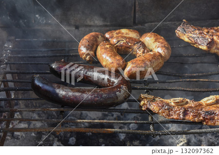 Barbecue, grilled sausages and cow meat , traditional argentine cuisine Barbecue, grilled sausages and cow meat , traditional argentine cuisine 132097362