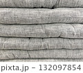 Stack of soft gray flat cushions neatly piled 132097854
