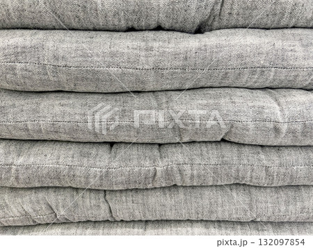 Stack of soft gray flat cushions neatly piled Stack of soft gray flat cushions neatly piled 132097854
