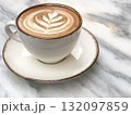 side view coffee with latte art on marble table in cafe 132097859