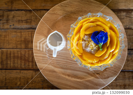 mango  sticky rice coconut milk on wooden table, popular traditional thai dessert 132099030