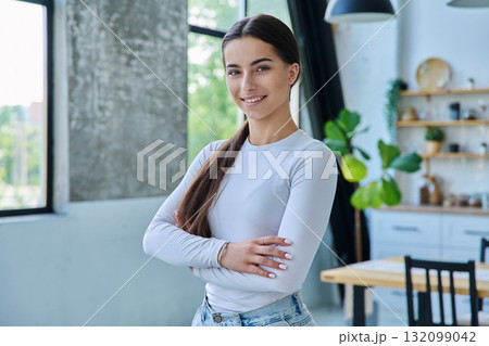 Portrait of confident successful teenage girl posing with crossed arms at home Portrait of confident successful teenage girl posing with crossed arms at home 132099042