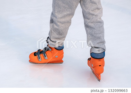 Person ice skating with orange skates on a rink in Seoul, South Korea Person ice skating with orange skates on a rink in Seoul, South Korea 132099663