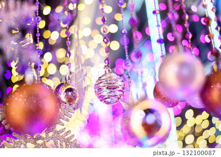 Colorful Baubles and Balls hanging decorated on christmas tree with bokeh light background Colorful Baubles and Balls hanging decorated on christmas tree with bokeh light background 132100087