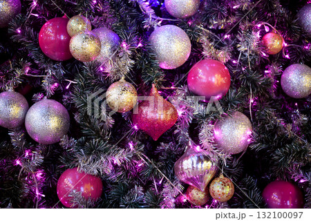 Colorful Baubles and Balls hanging decorated on christmas tree with bokeh light background 132100097