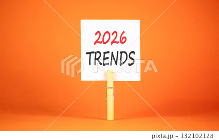 2026 Trends new year symbol. Concept words 2026 Trends on beautiful white paper on wooden clothespin. Beautiful orange background. Business and 2026 Trends new year concept. Copy space. 132102128