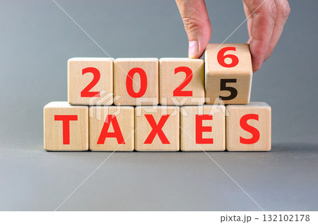 2026 taxes new year symbol. Concept words 2026 taxes on beautiful wooden blocks. Beautiful grey paper background. Businessman's hand. Business and 2026 taxes new year concept. Copy space. 2026 taxes new year symbol. Concept words 2026 taxes on beautiful wooden blocks. Beautiful grey paper background. Businessman's hand. Business and 2026 taxes new year concept. Copy space. 132102178
