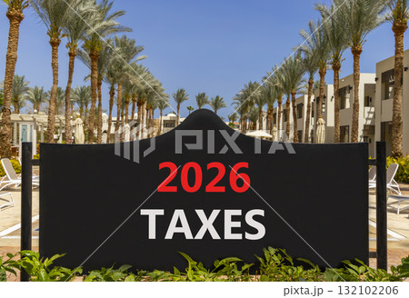 2026 taxes new year symbol. Concept words 2026 taxes on beautiful black road sign. Beautiful palm trees palm-trees and blue sky background. Business and 2026 taxes new year concept. Copy space. 2026 taxes new year symbol. Concept words 2026 taxes on beautiful black road sign. Beautiful palm trees palm-trees and blue sky background. Business and 2026 taxes new year concept. Copy space. 132102206