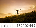 silhouette of happy woman relaxing on mountain hill  in summer sunset sky happy girl enjoying freedom and life raising arms feeling free 132102445