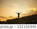 silhouette of happy woman relaxing on mountain hill  in summer sunset sky happy girl enjoying freedom and life raising arms feeling free 132102446