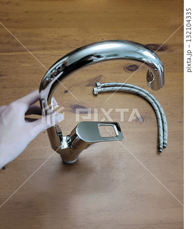 Silver Kitchen Faucet with Hoses in Hand Silver Kitchen Faucet with Hoses in Hand 132104335