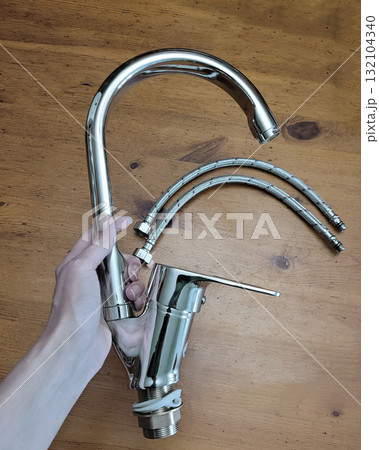 Silver Kitchen Faucet with Hoses in Hand Silver Kitchen Faucet with Hoses in Hand 132104340