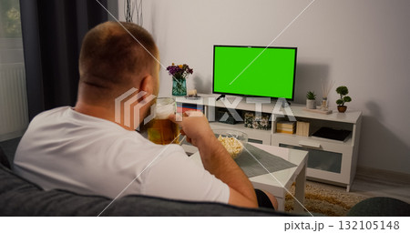 Man Watching Green Screen TV at home. Man Watching Green Screen TV at home. 132105148
