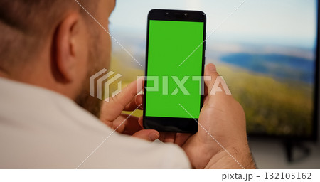 Man Watching on Smartphone Green Screen for Copy Space Chroma Key 132105162