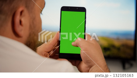 Man Using Smartphone with Green Screen for Copy Space Man Using Smartphone with Green Screen for Copy Space 132105163