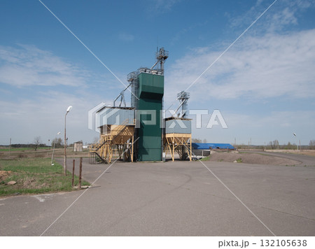 transport scene overview, industrial freight and grain storage, quiet transport hub with grain storage facilities, transport terminal featuring grain elevator and industrial surroundings 132105638