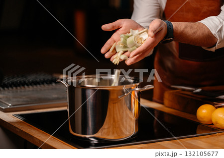 Prepping celery on cutting board ingredients in a large kitchen 132105677