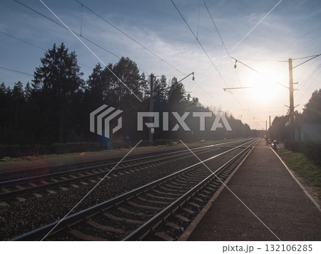 sunset scenes with train approaching, quiet platform with distant train lights approaching sunset scenes with train approaching, quiet platform with distant train lights approaching 132106285