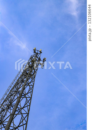 Wireless Communication Antenna pole, Mobile phone mast antenna pole on top of dilapidated building. 132106644