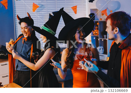 Joyful office Halloween party with coworkers in costumes, celebrating with drinks and laughter, fostering teamwork and festive spirit Joyful office Halloween party with coworkers in costumes, celebrating with drinks and laughter, fostering teamwork and festive spirit 132106669