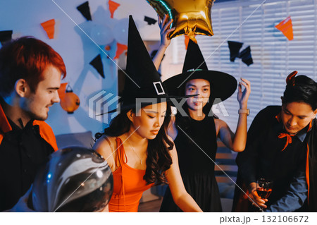 Joyful office Halloween party with coworkers in costumes, celebrating with drinks and laughter, fostering teamwork and festive spirit 132106672