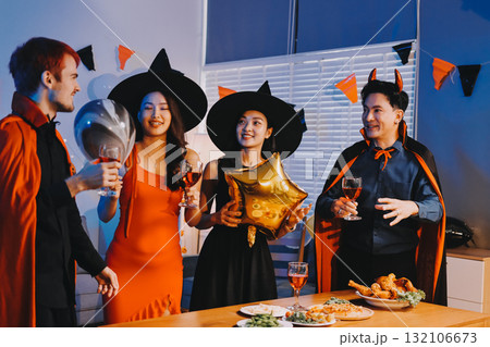 Joyful office Halloween party with coworkers in costumes, celebrating with drinks and laughter, fostering teamwork and festive spirit Joyful office Halloween party with coworkers in costumes, celebrating with drinks and laughter, fostering teamwork and festive spirit 132106673