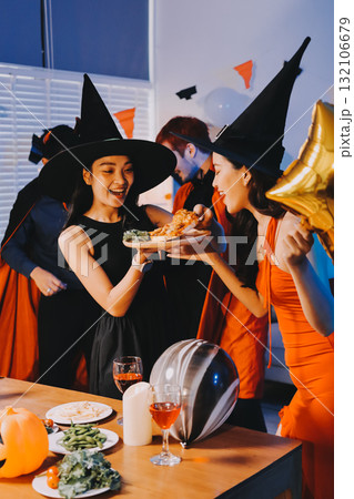 Joyful office Halloween party with coworkers in costumes, celebrating with drinks and laughter, fostering teamwork and festive spirit 132106679