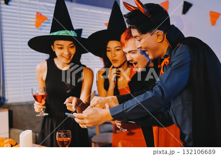 Joyful office Halloween party with coworkers in costumes, celebrating with drinks and laughter, fostering teamwork and festive spirit 132106689