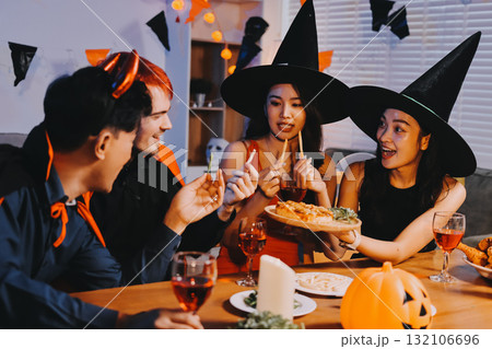 Joyful office Halloween party with coworkers in costumes, celebrating with drinks and laughter, fostering teamwork and festive spirit 132106696