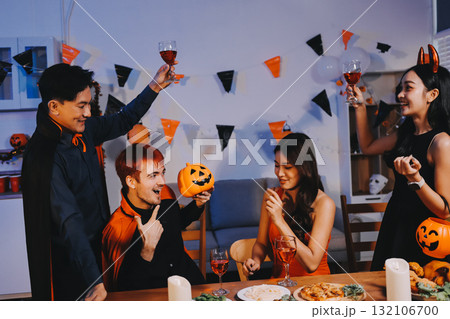 Joyful office Halloween party with coworkers in costumes, celebrating with drinks and laughter, fostering teamwork and festive spirit 132106700